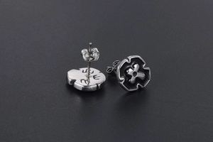 Macro view of 316L stainless steel cross star earring with vintage black enamel finish