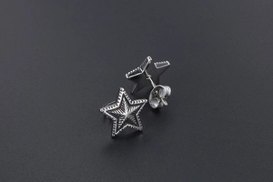 Macro shot of retro titanium steel star studs with radial texture and butterfly backs