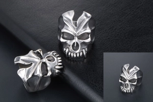 Detail view of gothic skull ring with vintage silver finish and embossed relief textures