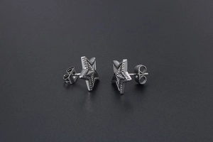 Macro detail of star stud earrings with vintage engraved radial stripes and secure backs