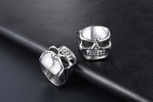 Detailed view of polished stainless steel skull rings with realistic punk carving detail
