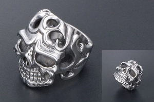 Detail of vintage gothic skull ring with intricate scroll patterns and matte finish