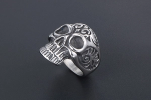 Macro view of vintage skull ring with detailed floral engravings on titanium steel