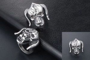 Macro view of retro gothic goat skull ring with detailed curved horns and silver texture
