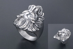 Macro shot of stainless steel lion head ring with detailed vintage engraving