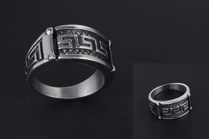 Macro detail of men's vintage steel ring featuring classic Greek meander pattern relief