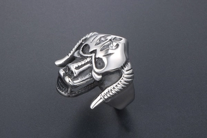 Macro detail of gothic bull horn monster ring with punk skull design in silver steel