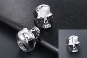 Macro view of polished gothic skull ring with star pattern in stainless steel metal