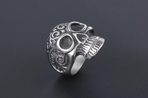 Macro detail of gothic skull ring in vintage silver finish with embossed side patterns