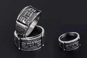 Macro detail of vintage titanium steel ring with meander pattern and textured edges