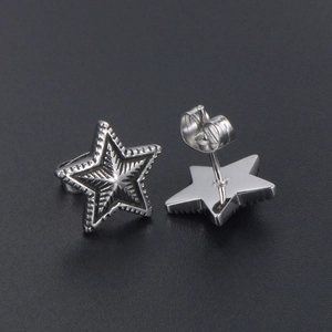 Vintage silver star stud earrings with radiating texture and butterfly backs