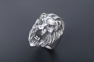 Close-up of a vintage lion head ring with detailed mane and roaring facial expression