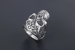 Detail view of gothic skull and floral relief pattern on vintage steel biker ring