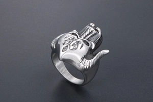 Macro view of gothic ram skull ring showing intricate horns and vintage steel texture