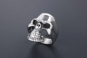 Detailed macro view of retro punk skull ring with polished and oxidized stainless steel finish