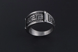 Macro detail of men's vintage titanium steel ring with engraved Greek meander pattern