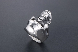 Macro detail of gothic skull ring in vintage stainless steel with embossed relief