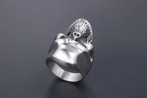 Detailed close-up of a punk style stainless steel skull ring with a vintage silver finish