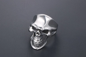 Detailed macro shot of punk style stainless steel skull ring with high polished finish