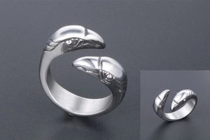 Detail of silver stainless steel open ring with dual eagle head design and polished finish