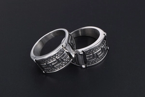 Macro view of stainless steel ring with Greek meander patterns on black background