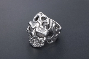 Detailed top view of a silver vintage skull ring featuring punk style hollow patterns