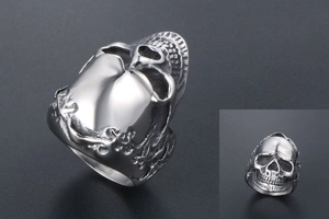 Macro view of vintage titanium steel skull ring with intricate floral carvings on the band