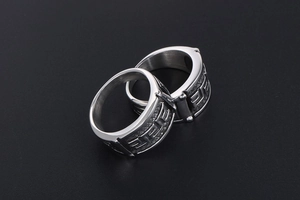 Detail of silver titanium steel rings featuring vintage Greek Meander pattern engravings
