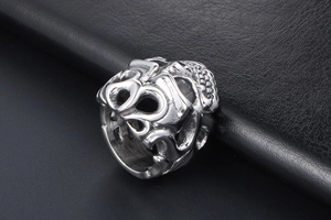 Macro detail of gothic skull ring with silver steel relief on black leather