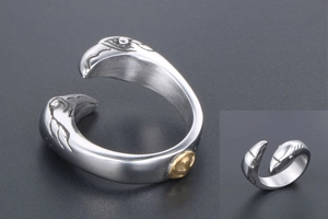 Detailed view of silver eagle head open ring with vintage brushed metal and gold emblem