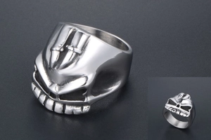 Macro shot of stainless steel skull ring featuring embossed crossed daggers detail