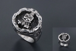 Close-up of gothic skull ring with shield emblem and chunky curb chain detailing