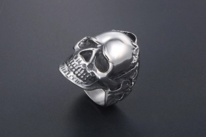 Macro side view of retro titanium skull ring with blackened vintage finish