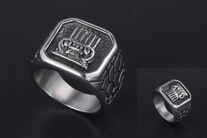 Macro shot of men's titanium steel signet ring with engraved crown and matte black texture
