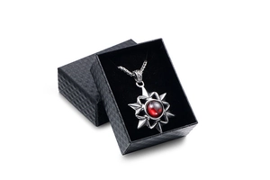 Octagon star pendant with red gemstone and black textured jewelry gift box display