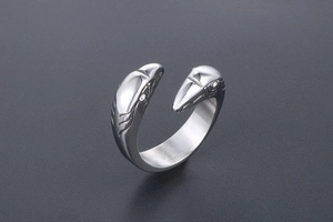 Macro shot of silver stainless steel adjustable ring with detailed twin eagle head carvings