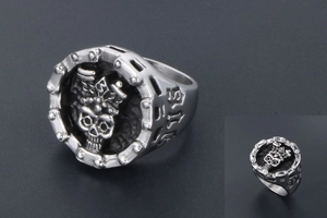 Detailed close-up of retro titanium steel skull ring with chain texture and punk aesthetic