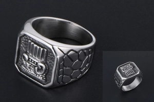 Macro detail of men's titanium ring featuring Greek column relief and stone texture