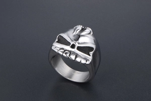 Close-up of rock punk style stainless steel skull ring with vintage black coating finish