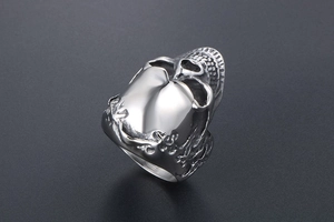 Macro detail of titanium steel skull ring featuring intricate punk floral engravings