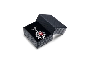 Octagon star pendant necklace with red gem in a black diamond pattern gift box