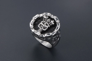 Macro detail of punk skull ring with crown, bike chain design and 918 engraving