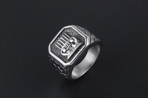 Macro shot of silver titanium steel signet ring with engraved classical pattern and textures