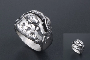 Detailed close-up of retro silver stainless steel ring with embossed Kylin pattern