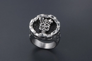 Macro detail of gothic skull ring with chain link edges in vintage stainless steel