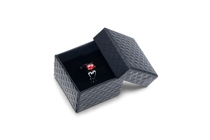 Retro ring with red round gemstone and heart cutout in a black diamond textured gift box