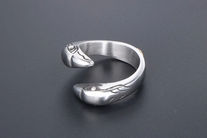 Macro detail of antique silver eagle head engraving on adjustable steel ring
