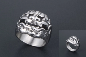 Detailed macro view of vintage stainless steel lion head ring with embossed texture
