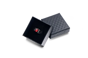 Retro black gothic ring with red oval gemstone presented in a textured gift box