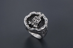 Detailed macro view of vintage skull robot relief on stainless steel chain ring